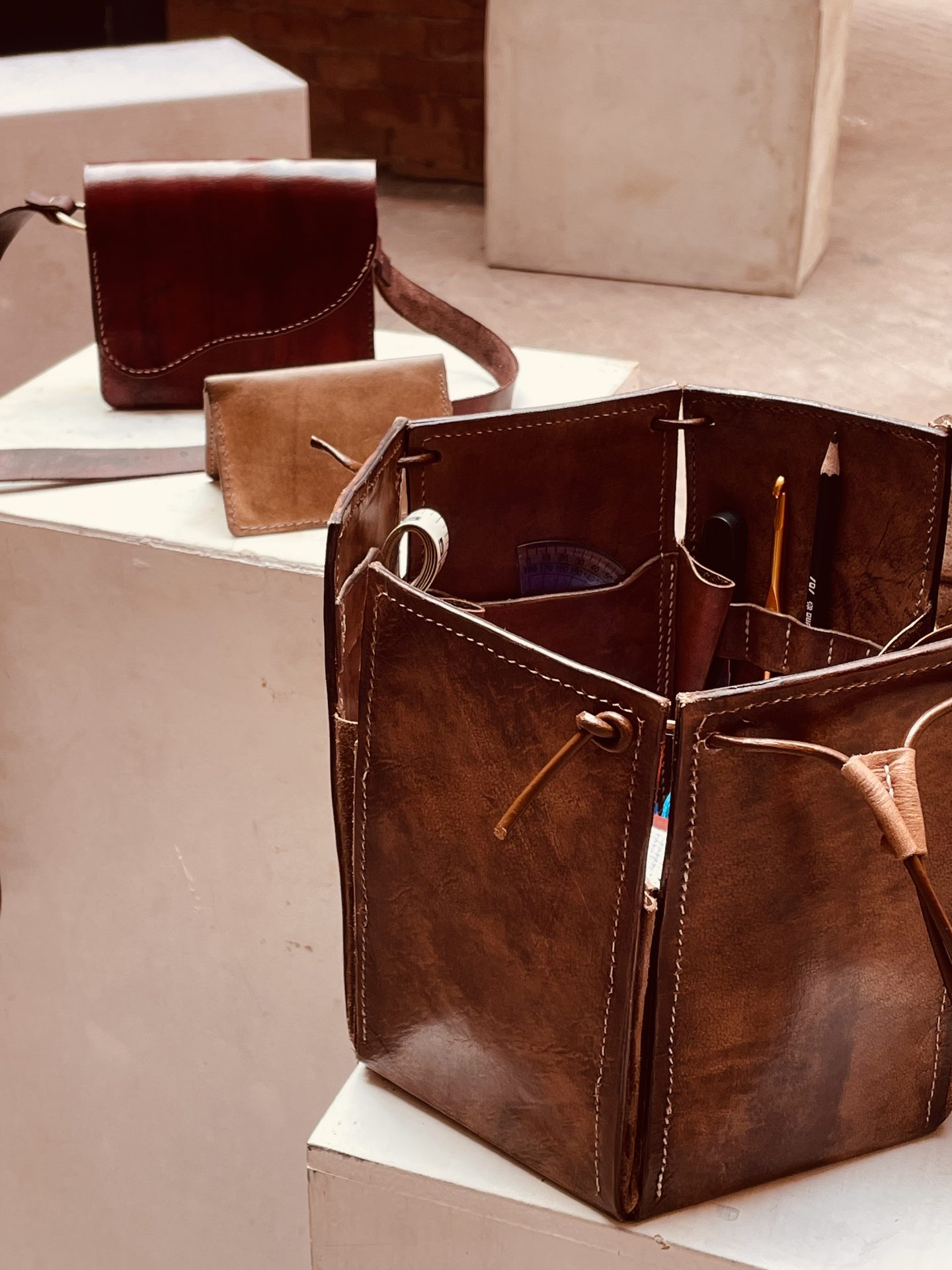Bucket bag and saddle bag displayed together