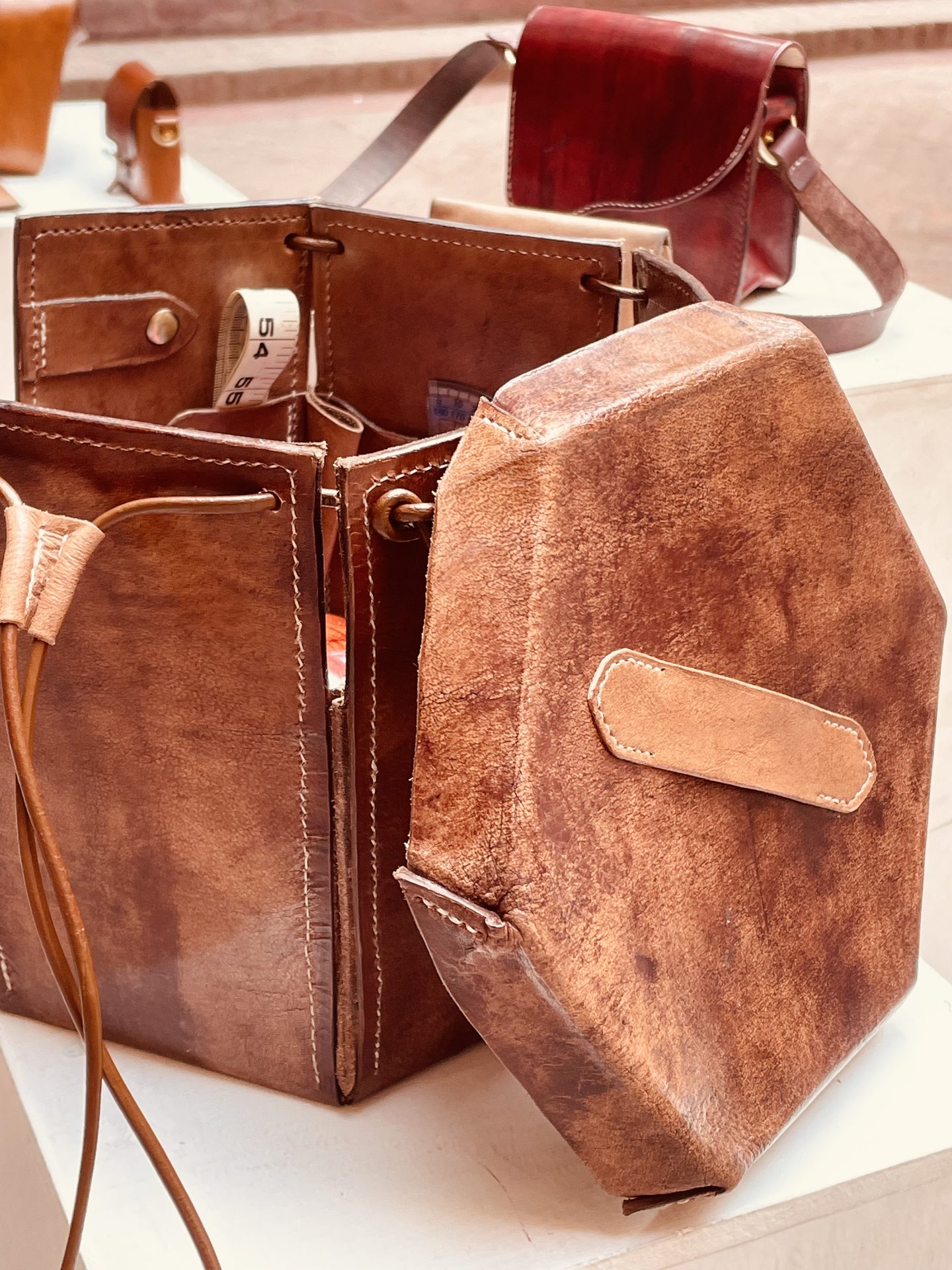 Bucket bag with lid open on display plinth
