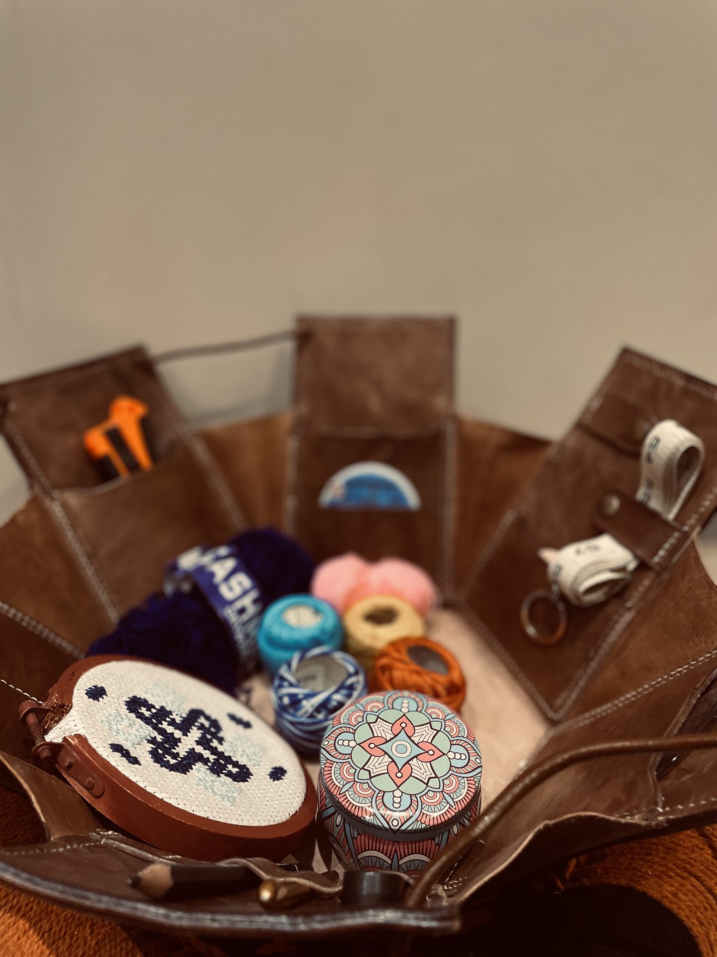 Interior pocket holding yarn and embroidery hoop