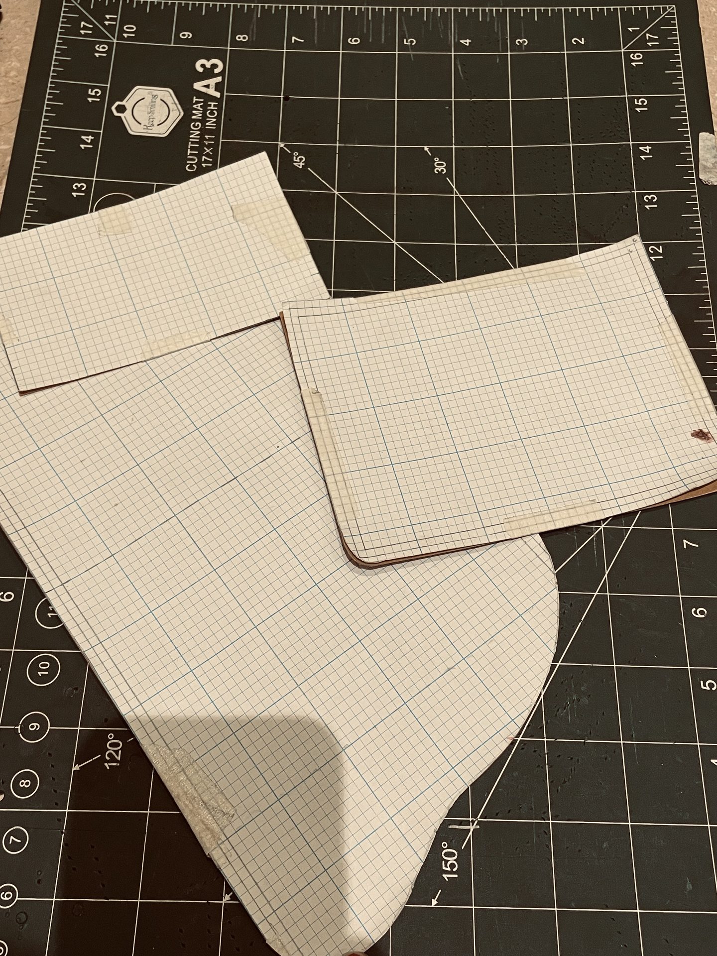 Hand-drawn wallet pattern stencils on graph paper
