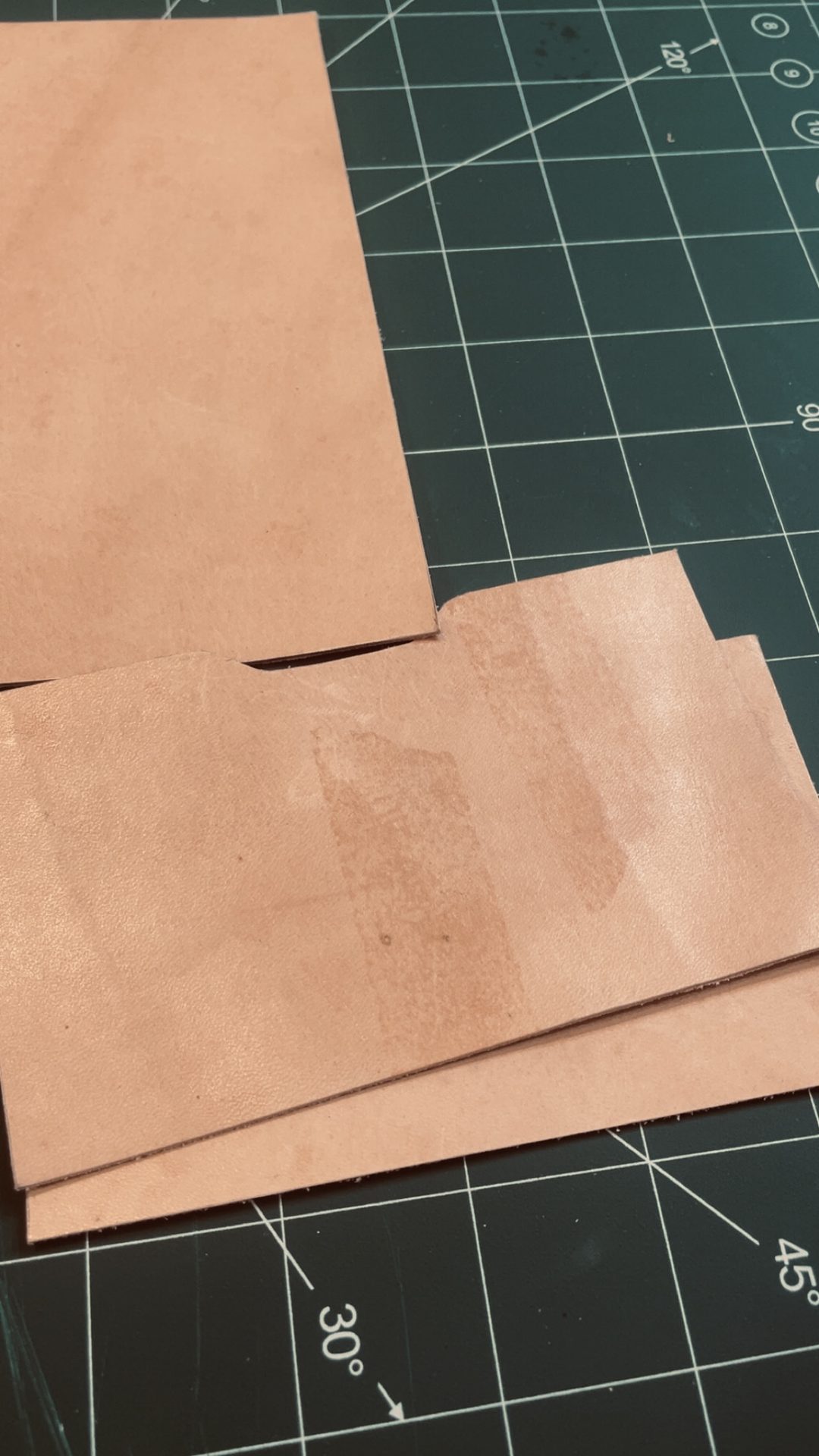 Vegetable-tanned leather panels cut on a cutting mat