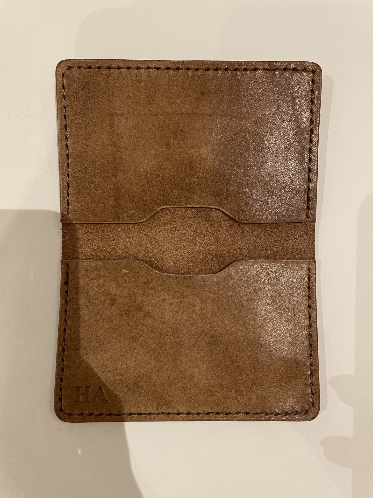 Hand-stitched bifold leather wallet, open