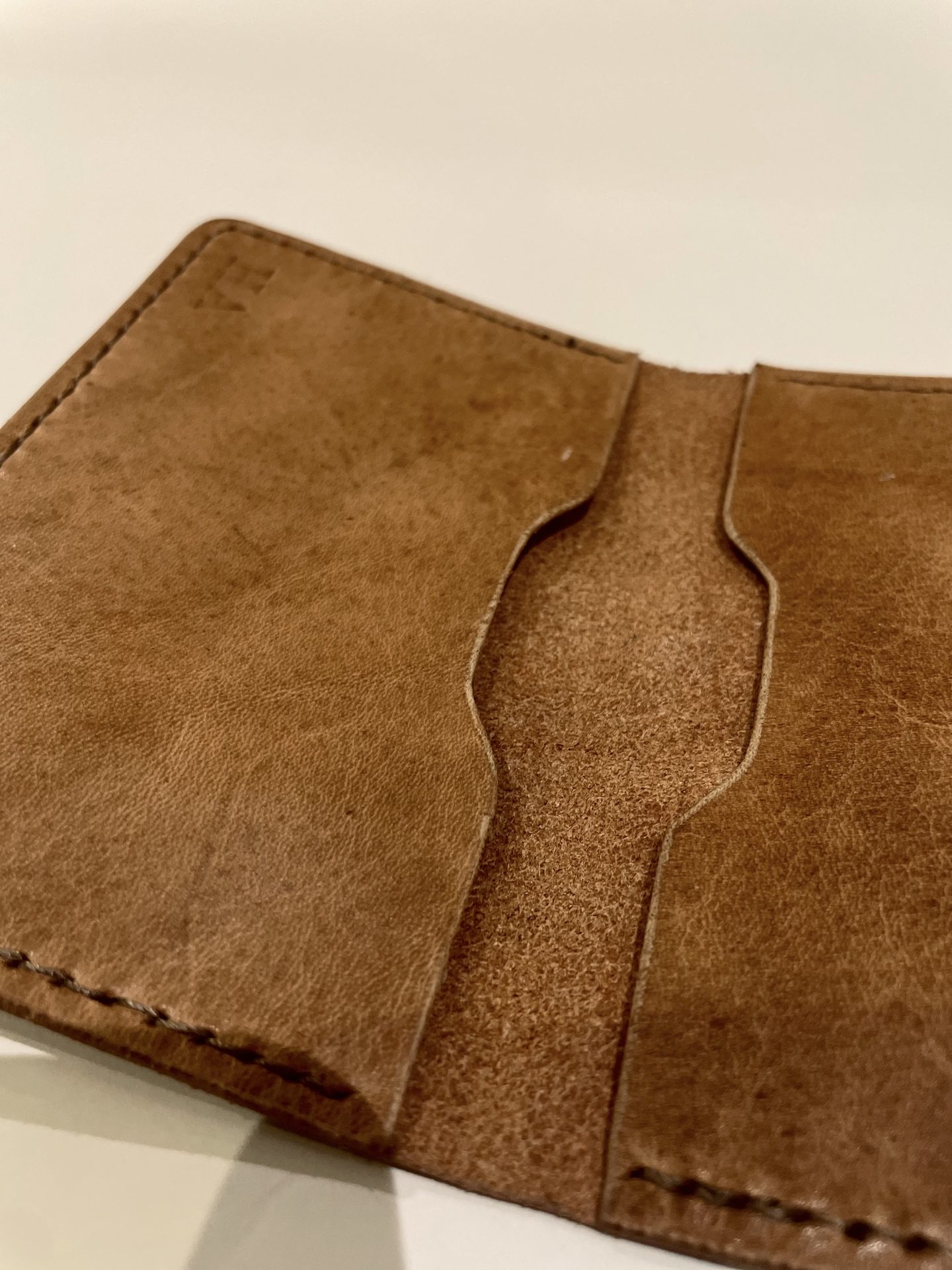 Detail of hand-stitched fold on leather wallet