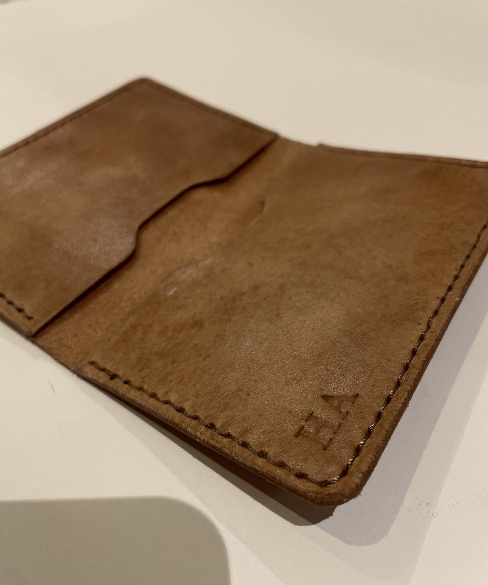 Open wallet with HA monogram stamped on interior panel