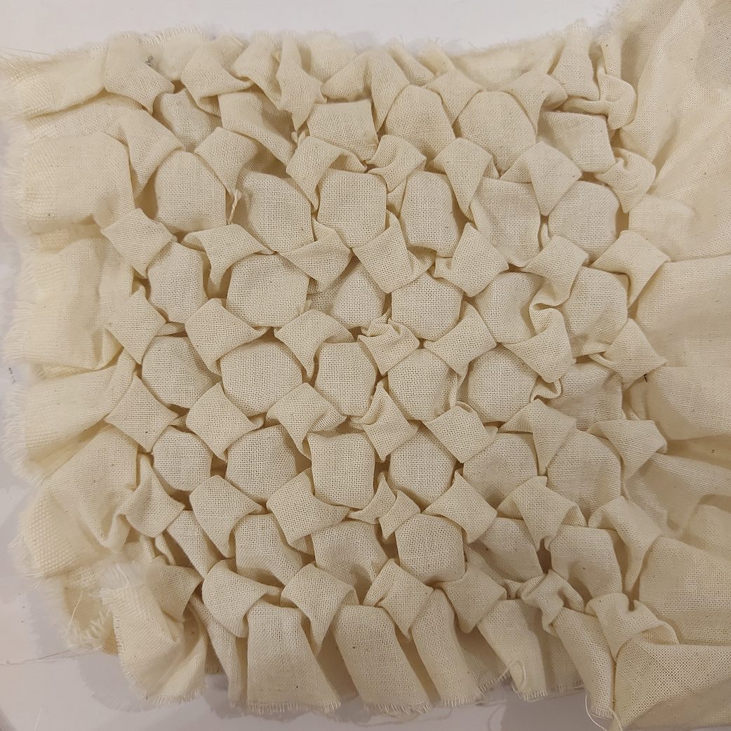 Hand-smocked cotton with raised honeycomb texture