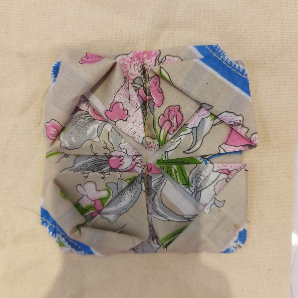 Floral printed fabric folded into a square origami block