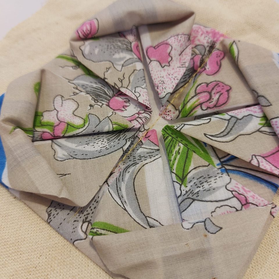 Floral fabric folded into a radial pinwheel