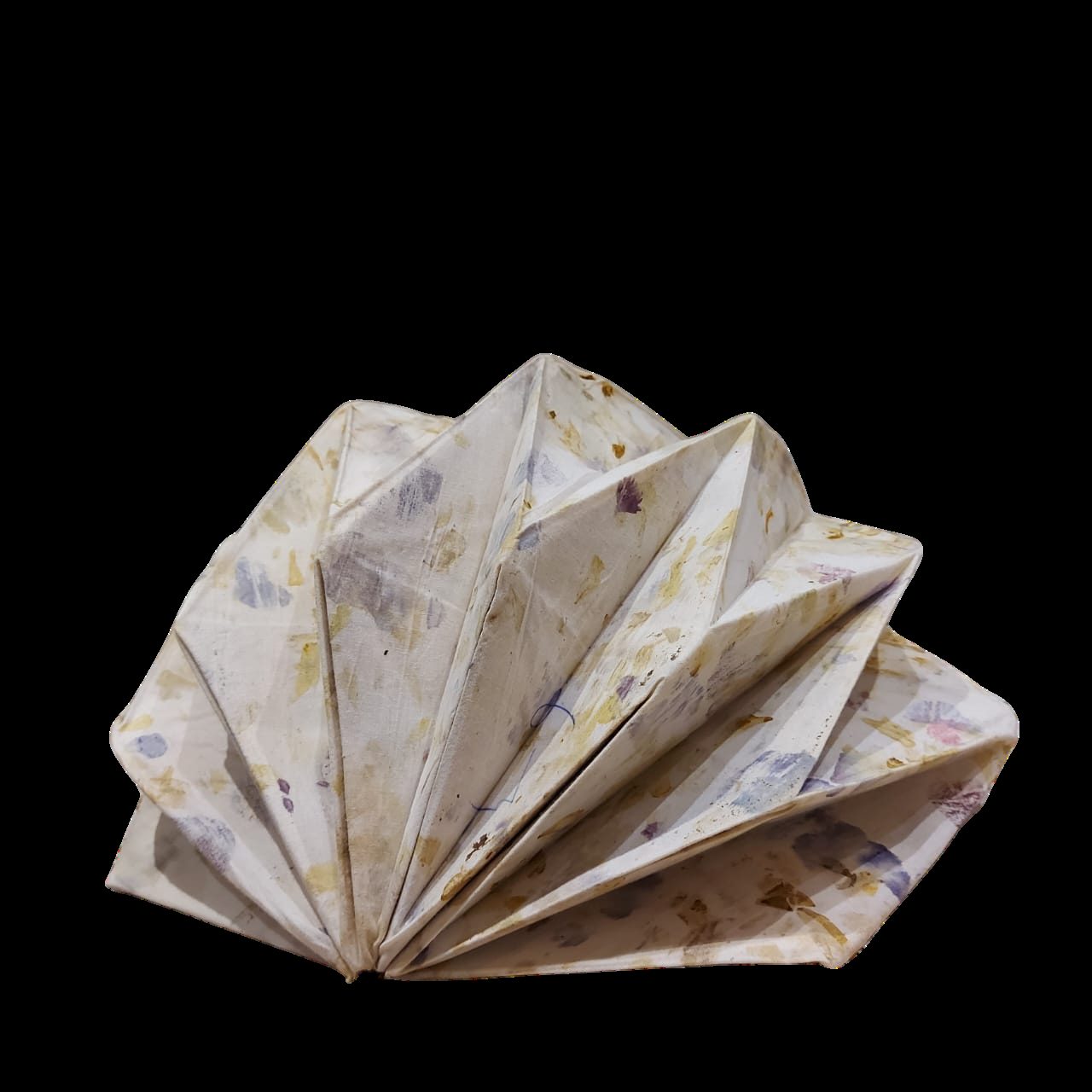 Eco-printed folded form against a black background