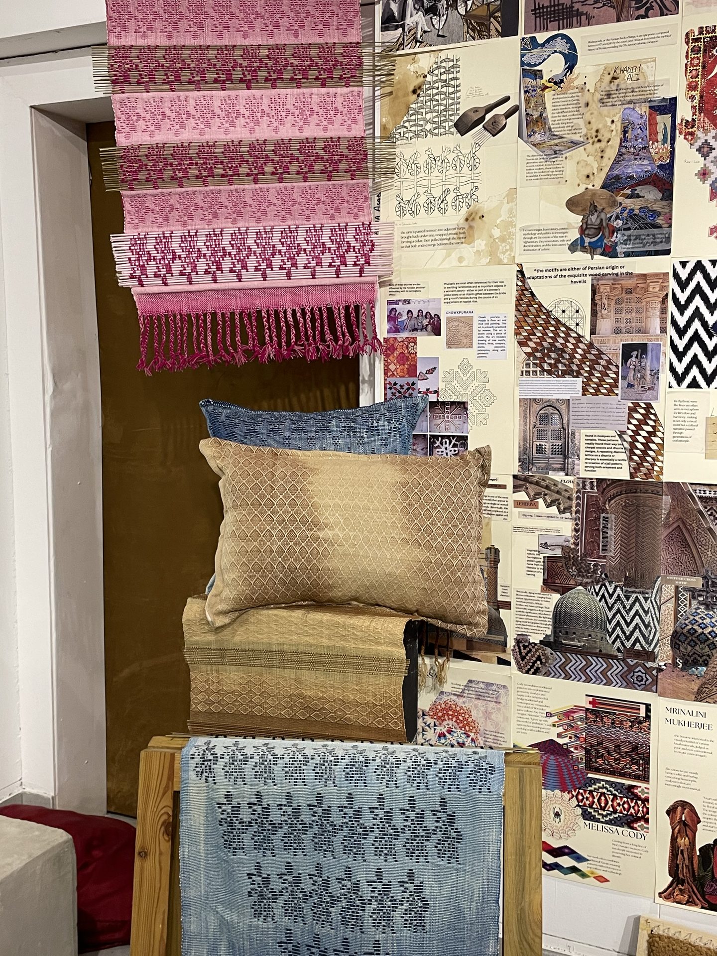 Studio installation with woven textiles and mood board