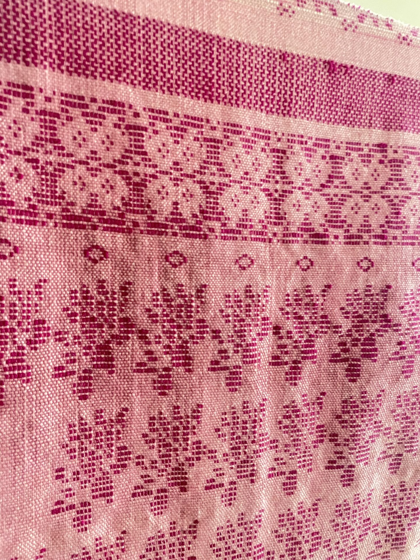 Detail of pink woven floral textile