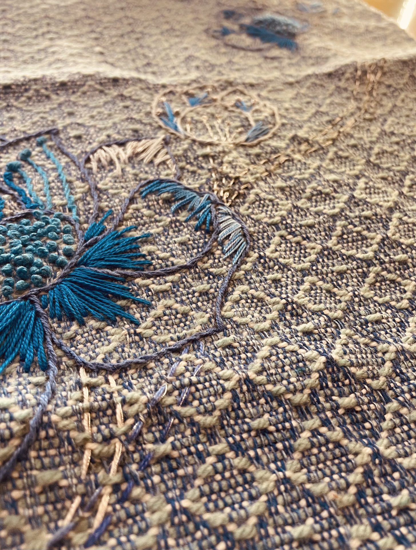 Blue lotus motif embroidery on woven ground
